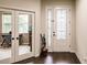 Bright entryway with glass French doors and hardwood floors at 30120 Hackney Loop, Mount Dora, FL 32757