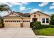 Two-story house with three-car garage, stone accents, and lush landscaping at 30120 Hackney Loop, Mount Dora, FL 32757