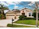 Two-story house with a three-car garage, landscaping, and a mailbox at 30120 Hackney Loop, Mount Dora, FL 32757