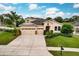 Two-story house with a three-car garage, stone accents, and a manicured lawn at 30120 Hackney Loop, Mount Dora, FL 32757