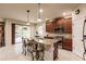 Island kitchen features granite countertops, stainless steel appliances, and access to backyard at 30120 Hackney Loop, Mount Dora, FL 32757