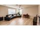 Living room with curved sectional sofa and hardwood floors at 30120 Hackney Loop, Mount Dora, FL 32757