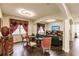 Open living space with hardwood floors, curved sofa, and built-in shelving at 30120 Hackney Loop, Mount Dora, FL 32757
