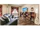 Living room with curved sofa, built-in shelving, and hardwood floors at 30120 Hackney Loop, Mount Dora, FL 32757