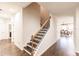 Elegant staircase with dark wood treads and wrought iron railing at 30120 Hackney Loop, Mount Dora, FL 32757