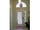 Inviting entryway with a stained glass sidelight at 2325 Paulette Dr, Haines City, FL 33844