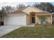 One-story house with attached garage and landscaped lawn at 2325 Paulette Dr, Haines City, FL 33844