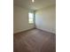 Cozy bedroom with neutral carpet, a window, and ample natural light at 4275 Sw 106Th Pl, Ocala, FL 34476
