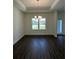 Formal dining room with decorative ceiling, wood-look tile, and bright window at 4275 Sw 106Th Pl, Ocala, FL 34476