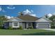 Charming one-story home featuring a neutral color, a gray garage door, manicured lawn, and minimal landscaping at 4275 Sw 106Th Pl, Ocala, FL 34476