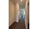 Hallway with wood-look tile, access to rooms, and neutral paint at 4275 Sw 106Th Pl, Ocala, FL 34476