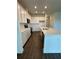 Modern kitchen features white cabinets, quartz countertop, and island with sink at 4275 Sw 106Th Pl, Ocala, FL 34476