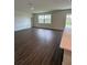 Open-concept living room featuring stylish wood-look tile flooring and natural light from a large window at 4275 Sw 106Th Pl, Ocala, FL 34476