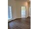 Bright living room with wood-look tile floors and natural light from the large window at 4275 Sw 106Th Pl, Ocala, FL 34476