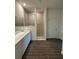 Bright bathroom featuring a walk-in shower, double vanity, and wood-look tile flooring at 4275 Sw 106Th Pl, Ocala, FL 34476