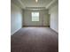 Spacious main bedroom with a tray ceiling and a large window for natural light at 4275 Sw 106Th Pl, Ocala, FL 34476