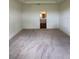 Carpeted main bedroom showcasing an ensuite bathroom through an open doorway at 4275 Sw 106Th Pl, Ocala, FL 34476