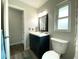 Bathroom featuring a sleek vanity, framed mirror, updated fixtures, and vinyl flooring at 1223 Lawrence Ave, Deltona, FL 32725