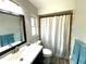 Updated bathroom featuring a shower with a decorative curtain and a modern vanity at 1223 Lawrence Ave, Deltona, FL 32725