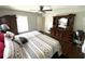 Bedroom featuring a large dresser and a comfortable bed with a patterned duvet at 1223 Lawrence Ave, Deltona, FL 32725