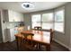 Dining area featuring a wooden table and chairs, with large windows for natural light at 1223 Lawrence Ave, Deltona, FL 32725