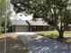 Charming single-story brick home features a two-car garage and a spacious front yard with mature shade tree at 1223 Lawrence Ave, Deltona, FL 32725