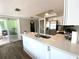 Bright kitchen with stainless steel appliances and sliding door to outside patio at 1223 Lawrence Ave, Deltona, FL 32725