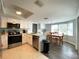Bright eat-in kitchen features white cabinets, stainless steel appliances, and ample natural light at 1223 Lawrence Ave, Deltona, FL 32725