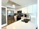 Bright kitchen with white cabinets and stainless steel appliances at 1223 Lawrence Ave, Deltona, FL 32725