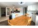 Bright kitchen with white cabinets, stainless steel appliances and adjacent wooden dining table at 1223 Lawrence Ave, Deltona, FL 32725