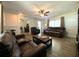 Cozy living room with laminate floors, ample seating, and a view into the adjacent dining area at 1223 Lawrence Ave, Deltona, FL 32725