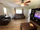 Comfortable living room with ceiling fan, laminate flooring, neutral paint, and view of adjacent kitchen at 1223 Lawrence Ave, Deltona, FL 32725