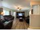 Spacious living room featuring laminate flooring, comfortable leather sofas, and a built-in entertainment center at 1223 Lawrence Ave, Deltona, FL 32725
