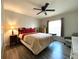 Cozy main bedroom with wood floors, queen bed, and large window at 1223 Lawrence Ave, Deltona, FL 32725