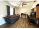Office area with hardwood floors, couch, desk, and natural lighting at 1223 Lawrence Ave, Deltona, FL 32725