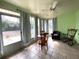 Cozy sunroom with tile flooring, ample seating, and serene views of the backyard at 1223 Lawrence Ave, Deltona, FL 32725