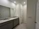 Modern bathroom features a dual sink vanity with granite countertops and tiled floors at 5640 Sw 117Th Lane Rd, Ocala, FL 34476