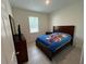Bright bedroom features a large window for natural light, neutral paint and tiled floors at 5640 Sw 117Th Lane Rd, Ocala, FL 34476