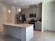 Modern kitchen featuring stainless steel appliances, granite countertops, and a large island at 5640 Sw 117Th Lane Rd, Ocala, FL 34476