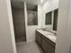 Modern main bathroom features a dual sink vanity, granite countertops and a tiled walk-in shower at 5640 Sw 117Th Lane Rd, Ocala, FL 34476