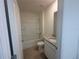 Bathroom featuring tiled floors, tub, and a sink with a light-colored granite countertop at 999 Brooklet Dr, Davenport, FL 33837