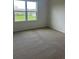Bedroom featuring a large window overlooking a green space and body of water at 999 Brooklet Dr, Davenport, FL 33837