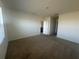 Spacious bedroom with neutral carpet, fresh white paint, and ample natural light at 999 Brooklet Dr, Davenport, FL 33837