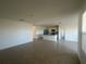 Open floor plan living room with tile floors, bright natural light, and seamless access to the kitchen at 999 Brooklet Dr, Davenport, FL 33837