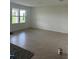 Bright living room with tile flooring and large windows overlooking the backyard at 999 Brooklet Dr, Davenport, FL 33837