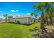 Lush backyard with palm trees, newly installed lawn, and neutral-colored exterior at 1840 India Palm Dr, Edgewater, FL 32141