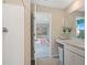 Modern bathroom with a shower and stylish vanity with a view into the bedroom at 1840 India Palm Dr, Edgewater, FL 32141