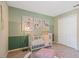 Charming Bedroom with neutral wall colors, white crib, and decorative ocean-themed art at 1840 India Palm Dr, Edgewater, FL 32141