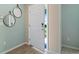 Inviting entryway featuring a white front door and stylish mirrors at 1840 India Palm Dr, Edgewater, FL 32141