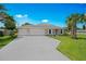 Charming single-story home with a well-manicured lawn, two-car garage, and beautiful landscaping at 1840 India Palm Dr, Edgewater, FL 32141